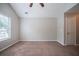 Bright bedroom with neutral walls, carpet, ceiling fan, and a window for natural light at 3777 Oakland Spring Ct, Snellville, GA 30039