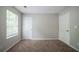 This vacant bedroom offers plush carpeting and neutral walls for a cozy and inviting space to unwind and relax at 3777 Oakland Spring Ct, Snellville, GA 30039