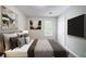 This bedroom features a neutral palette, stylish decor, and a large window for ample natural light at 3777 Oakland Spring Ct, Snellville, GA 30039