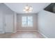 Inviting dining area featuring tile flooring, neutral walls, natural light and adjacent entryway and staircase at 3777 Oakland Spring Ct, Snellville, GA 30039