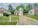 Charming two-story home with brick and vinyl siding, well-maintained lawn, and a private driveway at 3777 Oakland Spring Ct, Snellville, GA 30039