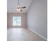 The expansive living room boasts a vaulted ceiling, light-colored tile floors, and ample natural light through a large window at 3777 Oakland Spring Ct, Snellville, GA 30039