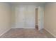A room with neutral carpet, neutral walls, and two doors, creating an adaptable space at 3856 Vine Stone Dr, Lithonia, GA 30038
