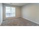 Sunny bedroom features large window, plush carpet, and neutral walls, creating a cozy retreat at 3856 Vine Stone Dr, Lithonia, GA 30038