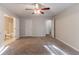 Spacious bedroom with plush carpeting, ceiling fan, and neutral paint, creating a calming atmosphere at 3856 Vine Stone Dr, Lithonia, GA 30038