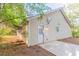 Rear exterior view of home with white siding, door to back patio at 3856 Vine Stone Dr, Lithonia, GA 30038