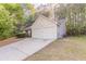 Exterior view showcasing a two-car garage and a long driveway at 3856 Vine Stone Dr, Lithonia, GA 30038