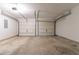 Spacious two-car garage featuring white walls and concrete flooring at 3856 Vine Stone Dr, Lithonia, GA 30038