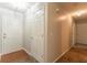 Neutral hallway with hardwood entry, carpet, and white doors at 3856 Vine Stone Dr, Lithonia, GA 30038