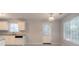 Functional kitchen with white cabinets, appliances, and backyard access at 3856 Vine Stone Dr, Lithonia, GA 30038