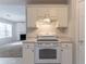 Bright kitchen with white appliances and a view into the adjacent living area at 3856 Vine Stone Dr, Lithonia, GA 30038