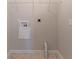 The laundry room features a wire rack with all of the necessary connections to hook up a dryer at 3856 Vine Stone Dr, Lithonia, GA 30038