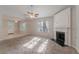 Bright living room featuring fireplace, ceiling fan, and lots of natural light at 3856 Vine Stone Dr, Lithonia, GA 30038
