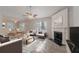 Open living room with a fireplace, ceiling fan, and adjacent dining area offers a cozy atmosphere at 3856 Vine Stone Dr, Lithonia, GA 30038