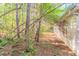 View of the side yard with natural landscaping and trees at 3856 Vine Stone Dr, Lithonia, GA 30038