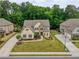 Aerial view of home on a well-manicured lawn, showcasing its architectural design and landscaping at 5250 Briarstone Ridge Way, Alpharetta, GA 30022