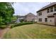 Well-maintained backyard with a view of the home's screened porch and manicured lawn at 5250 Briarstone Ridge Way, Alpharetta, GA 30022