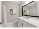 Bright bathroom featuring a shower and tub combination, a toilet, and a single sink vanity with black hardware at 5250 Briarstone Ridge Way, Alpharetta, GA 30022