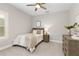 Cozy bedroom with a queen-sized bed, ceiling fan, and a neutral color palette at 5250 Briarstone Ridge Way, Alpharetta, GA 30022
