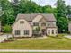Charming two-story home with brick and stone accents, manicured lawn and professionally landscaped yard at 5250 Briarstone Ridge Way, Alpharetta, GA 30022