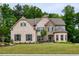 Beautiful two-story brick home with stone accents, manicured lawn, and mature trees in a well-maintained neighborhood at 5250 Briarstone Ridge Way, Alpharetta, GA 30022