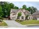 Two-story home with brick and stone facade, well-manicured lawn, and a three-car garage at 5250 Briarstone Ridge Way, Alpharetta, GA 30022