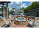 Inviting outdoor fire pit area with Adirondack chairs, perfect for socializing near the community pool at 5250 Briarstone Ridge Way, Alpharetta, GA 30022