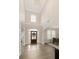 Bright foyer with soaring ceilings, hardwood floors, and large front door with transom window at 5250 Briarstone Ridge Way, Alpharetta, GA 30022