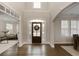 Elegant foyer with hardwood floors, high ceilings, and ample natural light pouring through the front door at 5250 Briarstone Ridge Way, Alpharetta, GA 30022