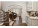 Elegant hallway leading to the dining room, featuring a staircase and a butler's pantry at 5250 Briarstone Ridge Way, Alpharetta, GA 30022