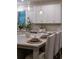 Kitchen island with pendant lighting, seating, and decorative backsplash at 5250 Briarstone Ridge Way, Alpharetta, GA 30022
