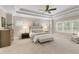 Spacious main bedroom with tray ceiling, carpeting, and multiple windows for natural light at 5250 Briarstone Ridge Way, Alpharetta, GA 30022
