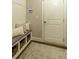 Mudroom features a bench with storage baskets, hooks, and a door, with neutral tones at 5250 Briarstone Ridge Way, Alpharetta, GA 30022