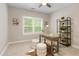 Well-lit office space featuring a window, a desk, a chair, a bookshelf, and a cowhide rug on neutral carpet at 5250 Briarstone Ridge Way, Alpharetta, GA 30022