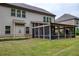 Expansive screened porch that offers ample space for dining and relaxation within a lush backyard setting at 5250 Briarstone Ridge Way, Alpharetta, GA 30022