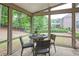 Cozy sunroom features an outdoor dining area and an adjacent yard view at 5250 Briarstone Ridge Way, Alpharetta, GA 30022