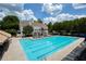 Inviting swimming pool with lap lanes, lounge chairs and umbrellas, with clubhouse in the background at 5250 Briarstone Ridge Way, Alpharetta, GA 30022