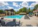 Stunning pool area with lounge chairs, tables, and umbrellas, perfect for relaxation and entertainment at 5250 Briarstone Ridge Way, Alpharetta, GA 30022