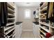 Walk-in closet with custom shelving, drawers, and hanging racks for optimal storage at 5250 Briarstone Ridge Way, Alpharetta, GA 30022