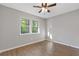 Cozy bedroom with a ceiling fan, a large window, and neutral decor at 622 Saddlewood Dr, Lawrenceville, GA 30043