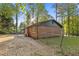 A view of the brick house and a fenced area in the backyard with green trees at 622 Saddlewood Dr, Lawrenceville, GA 30043