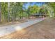Long driveway leads to a brick ranch-style home with a lush, wooded surround at 622 Saddlewood Dr, Lawrenceville, GA 30043
