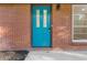 Close-up of the bright blue front door of a brick home with a modern window at 622 Saddlewood Dr, Lawrenceville, GA 30043