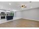 Open-concept living space featuring wood floors and view of kitchen with stainless appliances at 622 Saddlewood Dr, Lawrenceville, GA 30043