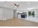Bright open-concept living space with wood floors connects kitchen and dining areas at 622 Saddlewood Dr, Lawrenceville, GA 30043