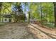 Landscape view showing the house and separate shed on the wooded lot at 622 Saddlewood Dr, Lawrenceville, GA 30043