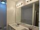 Modern bathroom with dual sinks, large mirror, and updated lighting at 815 Alta Ct, Lithonia, GA 30058