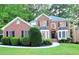 Charming two-story brick home with manicured lawn and lush landscaping at 815 Alta Ct, Lithonia, GA 30058