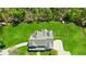 Aerial view of home with manicured lawn, a fire pit, and wooded perimeter at 1200 Old Lathemtown Rd, Canton, GA 30115