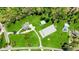 Aerial view of property featuring main house, separate apartment, barn and equestrian riding ring at 1200 Old Lathemtown Rd, Canton, GA 30115